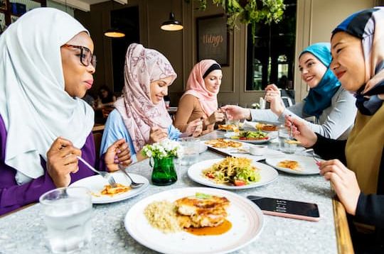 Group of Muslim women eating together