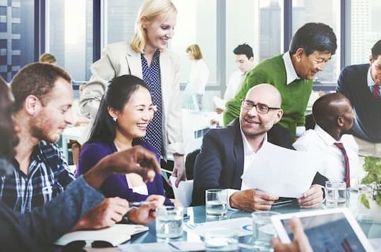 Coworkers collaborating around table at conference